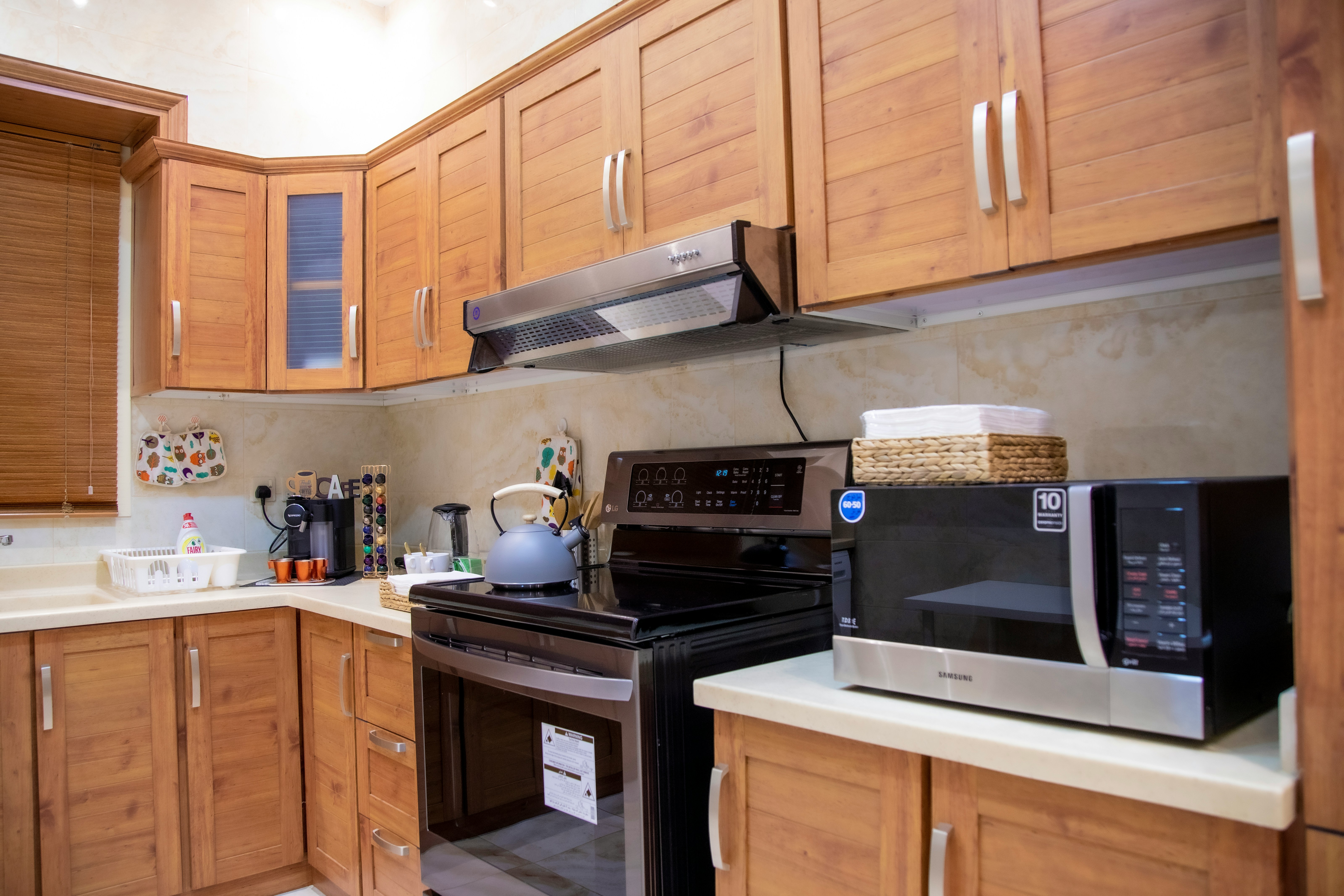 Modern kitchen cabinets with premium wood finishes by Eastgate Furnitures